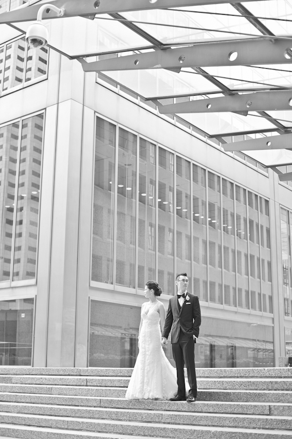bride and groom holding hands and looking the opposite direction- wedding photo by top Canadian wedding photographer Rebecca Wood